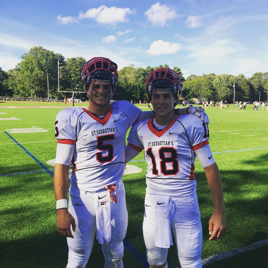 Billy Seidl posing with a friend in his football uniform