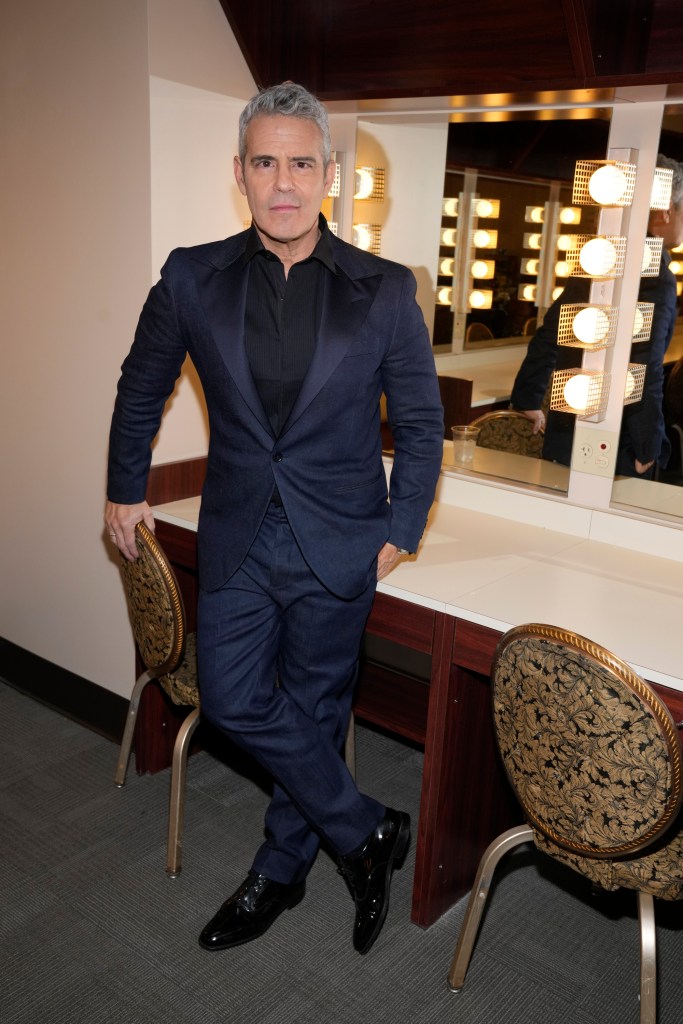 andy cohen posing in front of a vanity mirror