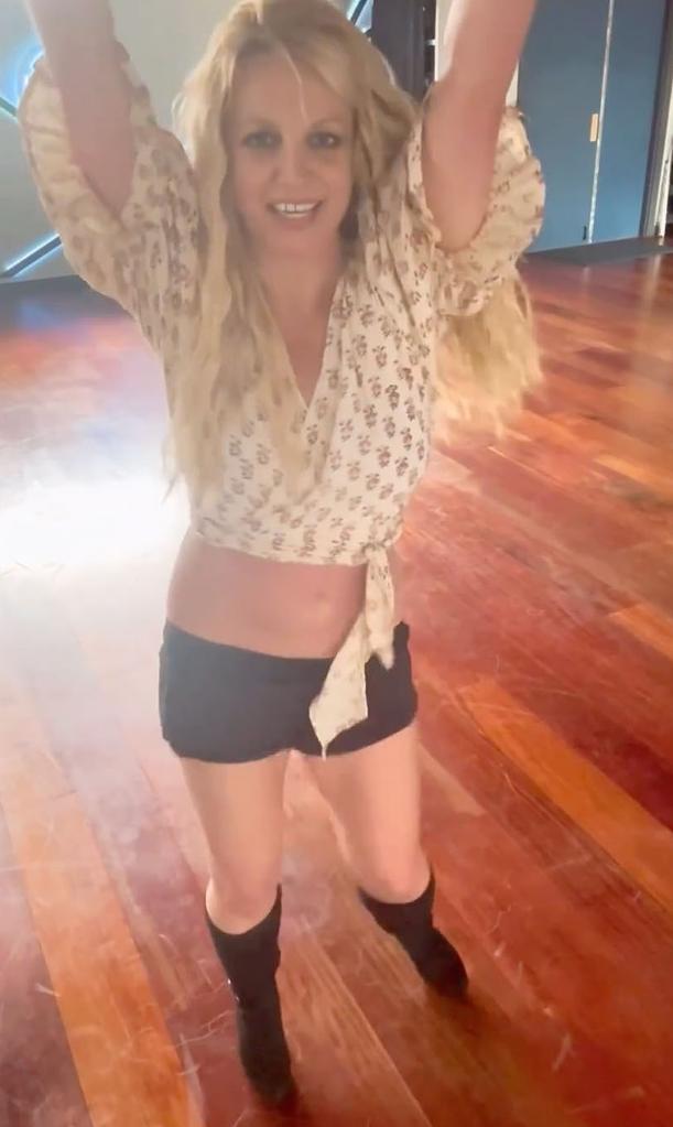 britney spears dancing with her arms raised