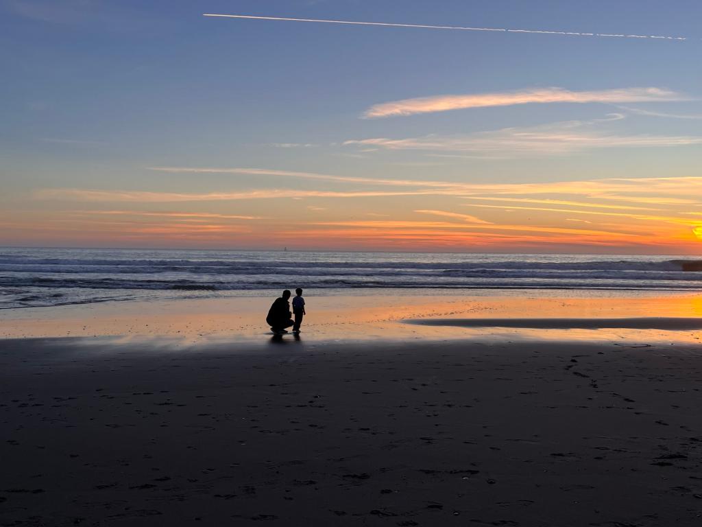 Bridgit Mendler and her adopted child on the beach.