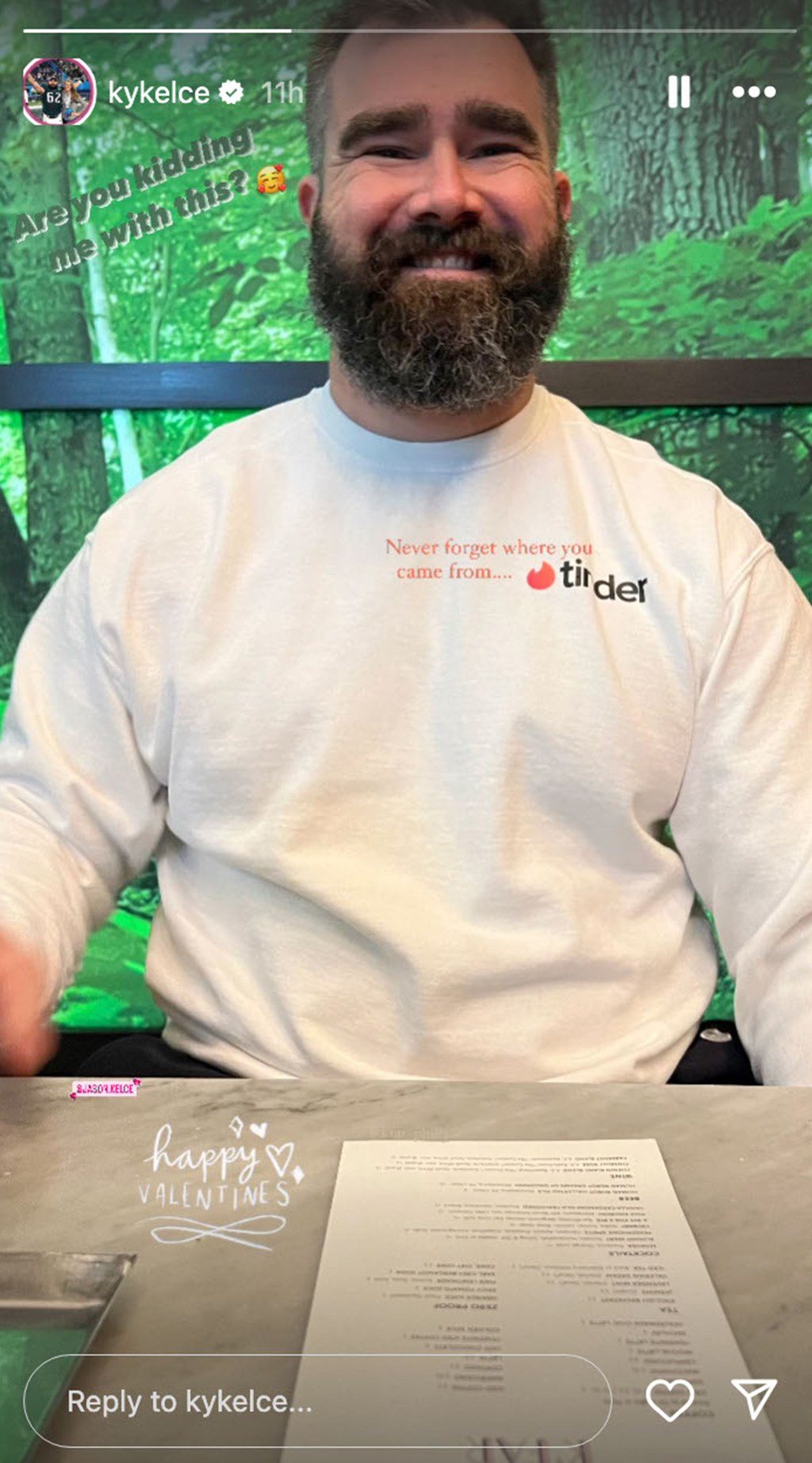 jason kelce smiling and wearing a Tinder sweatshirt