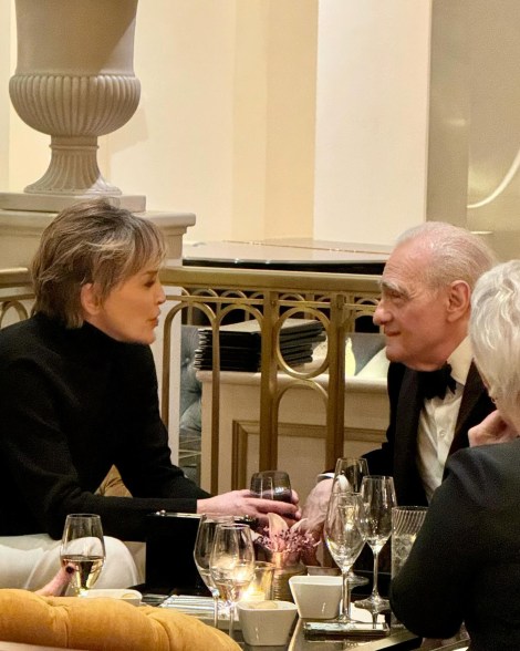 sharon stone and martin scorsese talking at a table