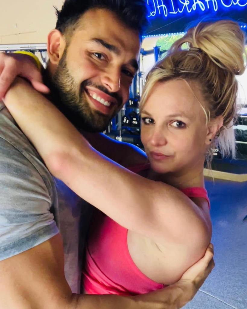 britney spears with her arms around sam asghari's neck