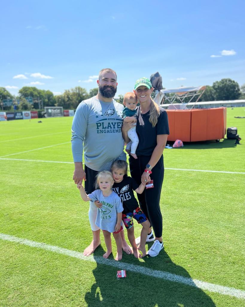 jason and kylie kelce with their three daughters on the football field