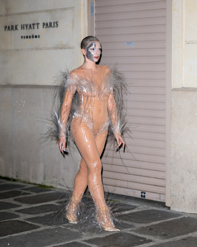 Julia Fox in barely there silver feathered outfit.