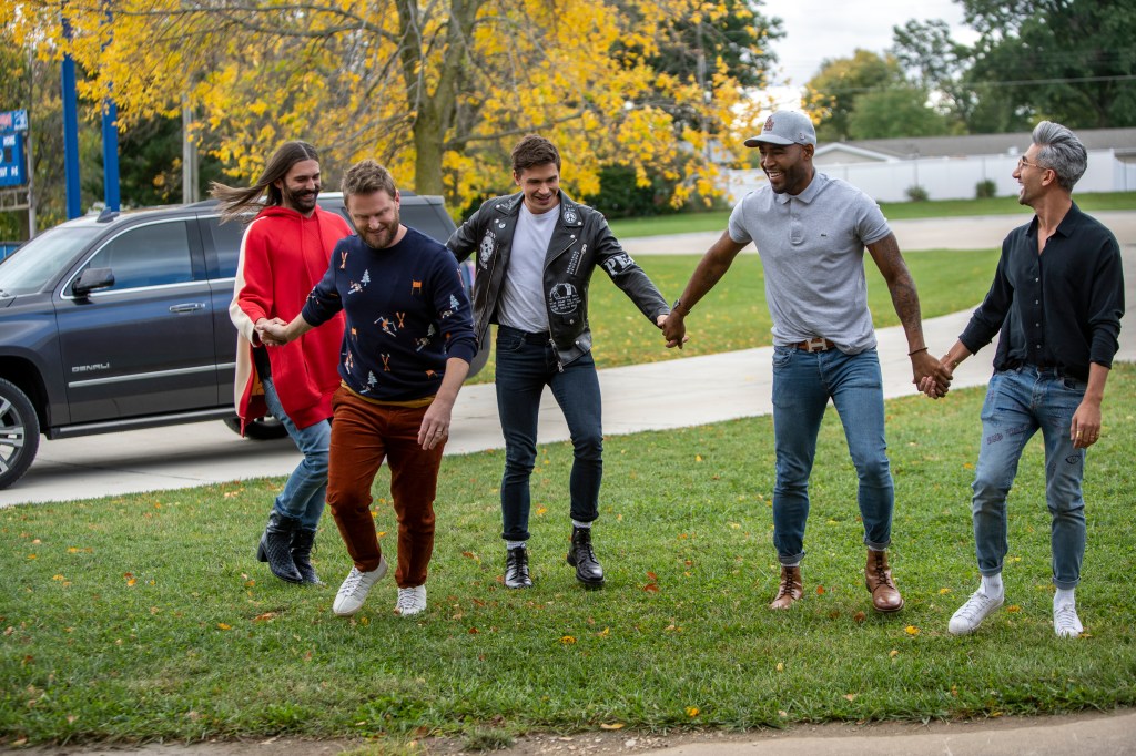 The cast of "Queer Eye" holding hands.