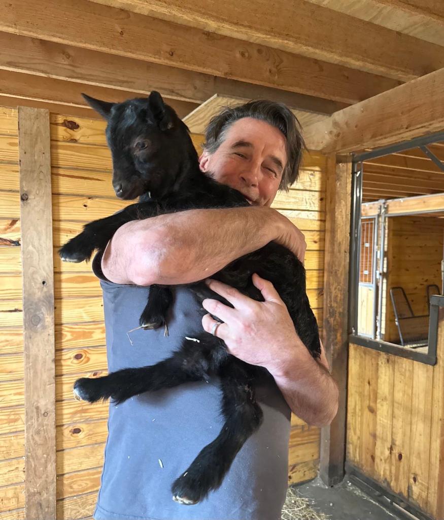 Billy Baldwin holding a goat