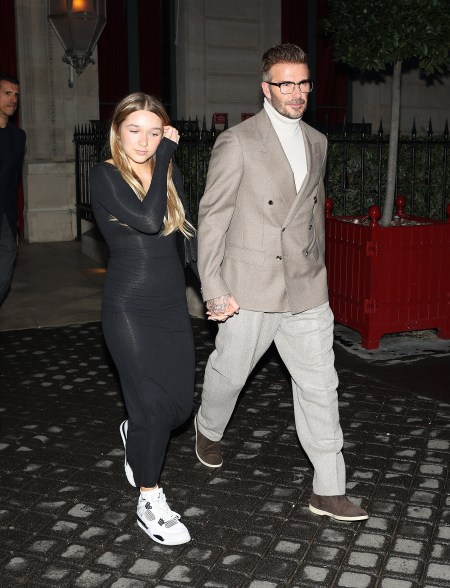 Harper and David Beckham attend the Victoria Beckham show during Paris Fashion Week on March 1, 2024.