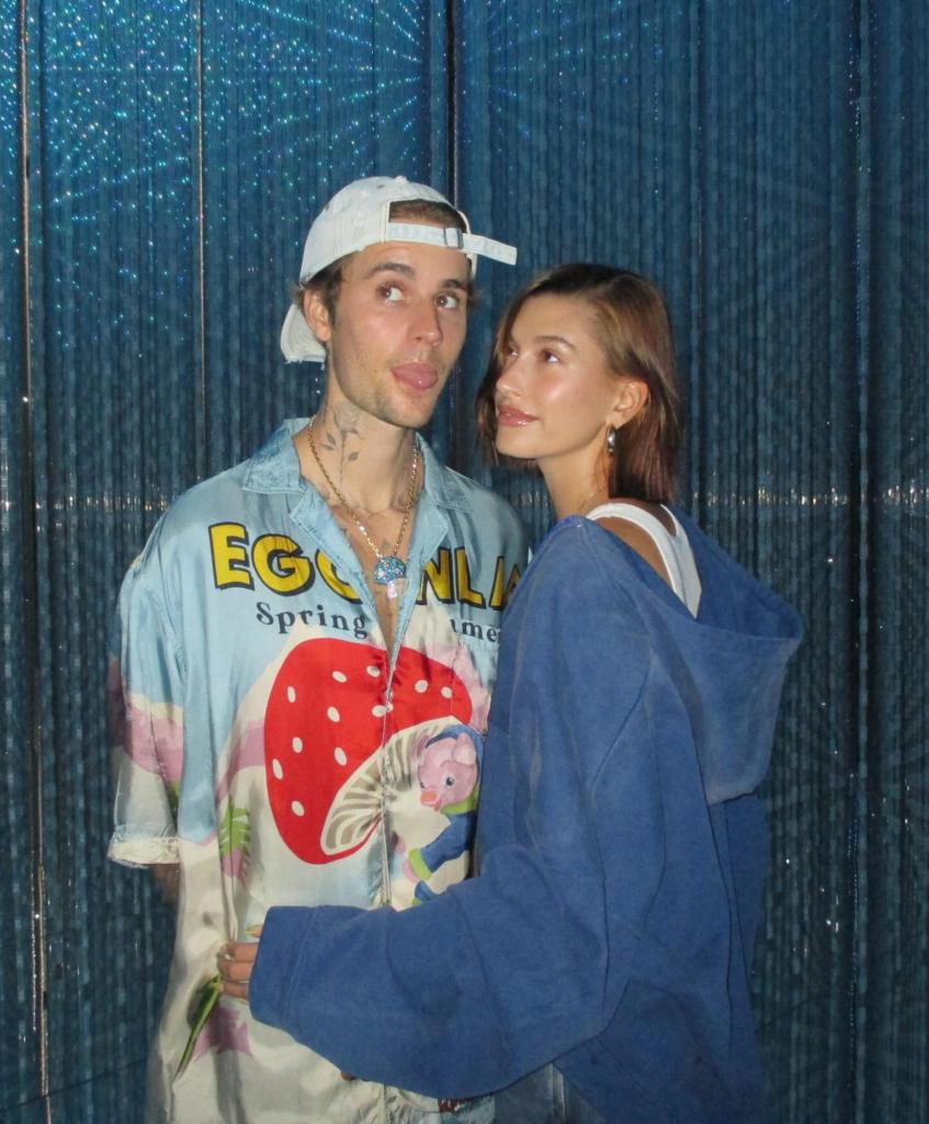 Hailey Bieber and Justin Bieber pose for a photo.