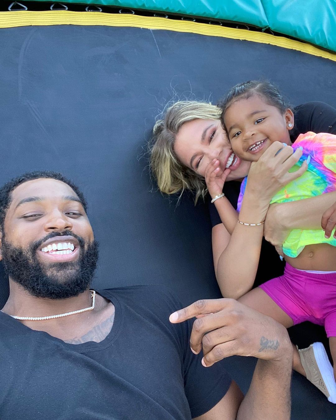 Khloé Kardashian, Tristan Thompson and True on a trampoline.