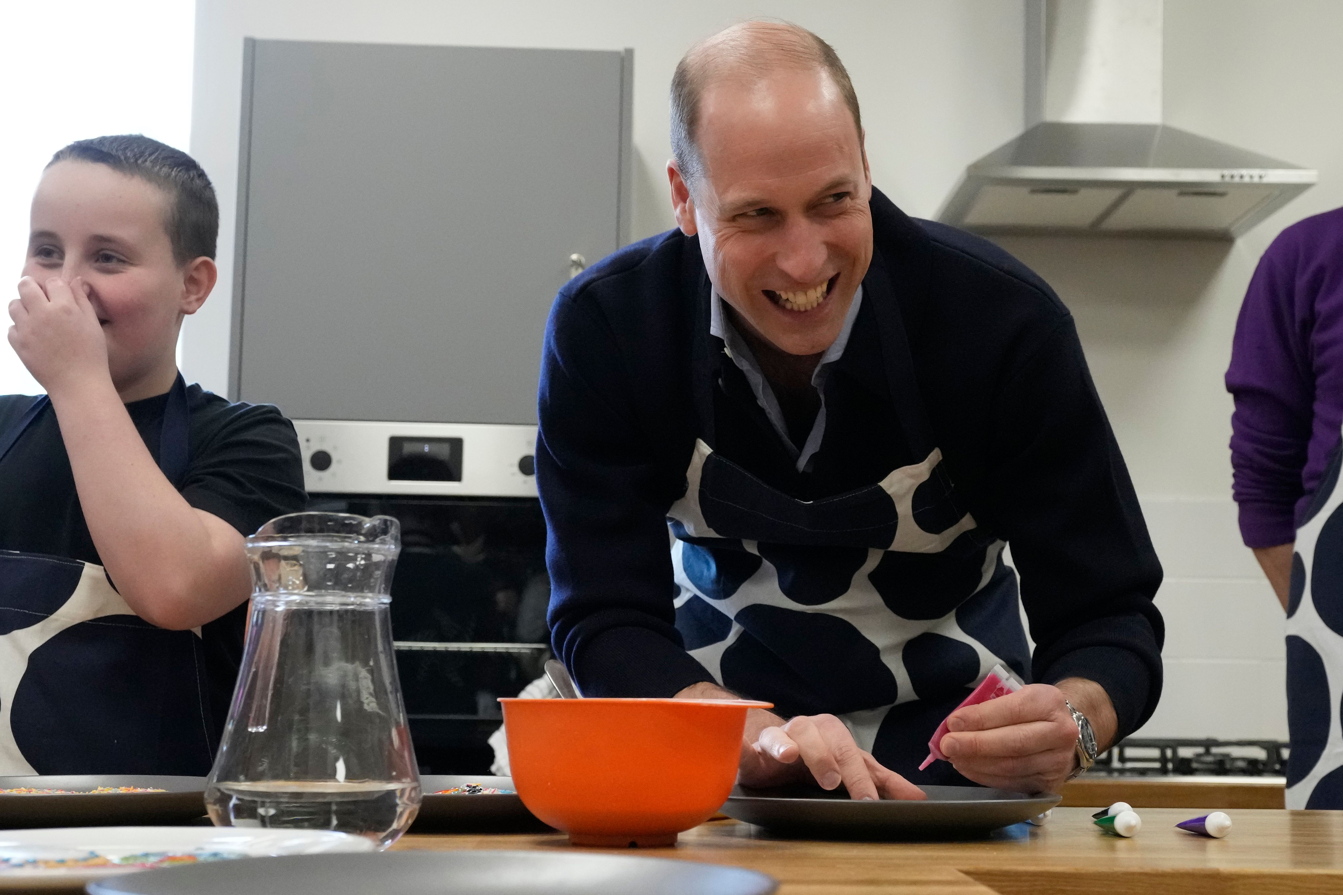 prince william working with kitchen supplies and smiling