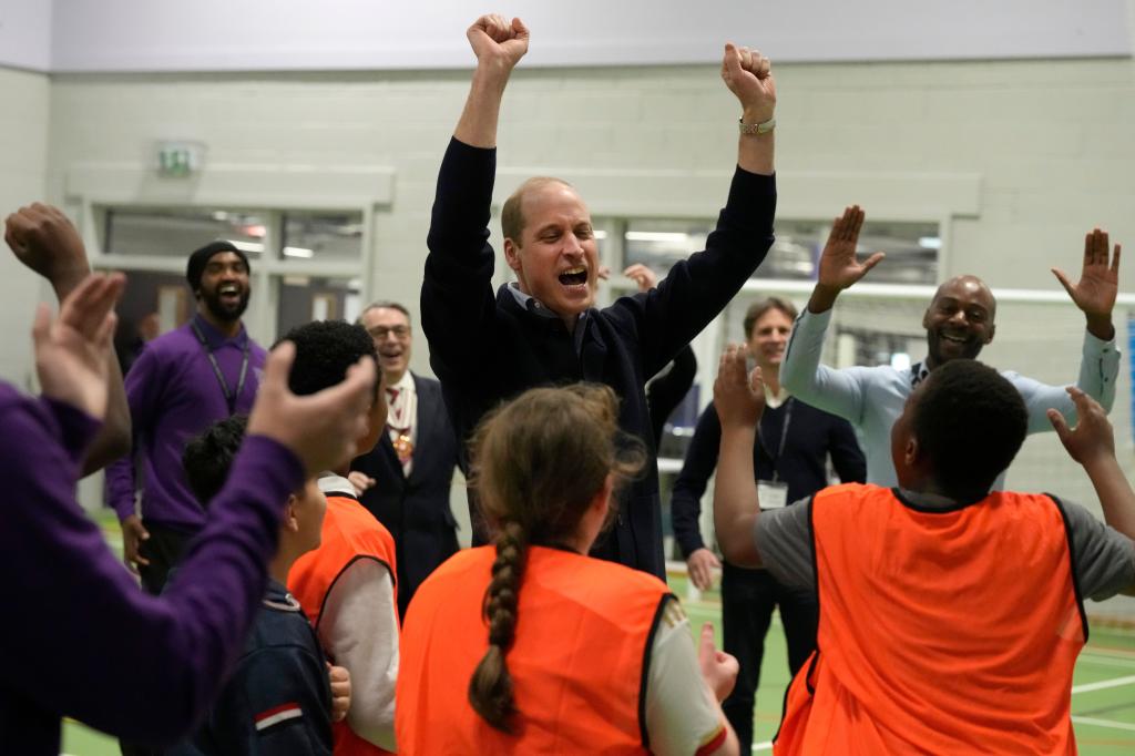 prince william cheering with a group of kids