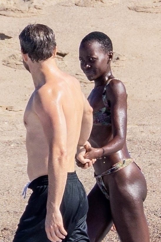 Lupita Nyong'o and Joshua Jackson on the beach in Mexico.