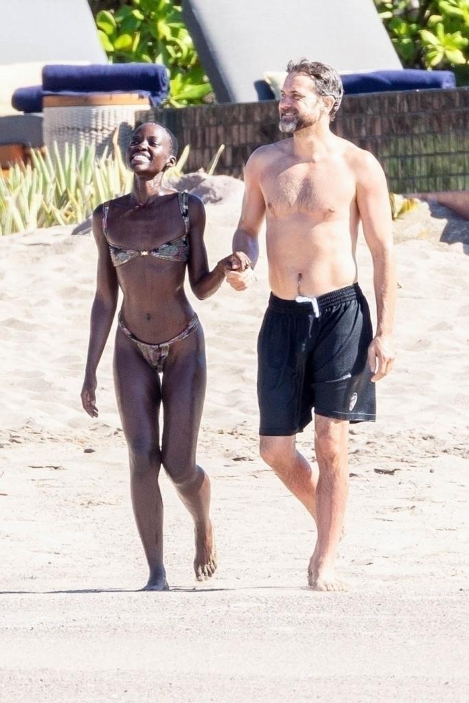 Lupita Nyong'o and Joshua Jackson on the beach in Mexico.