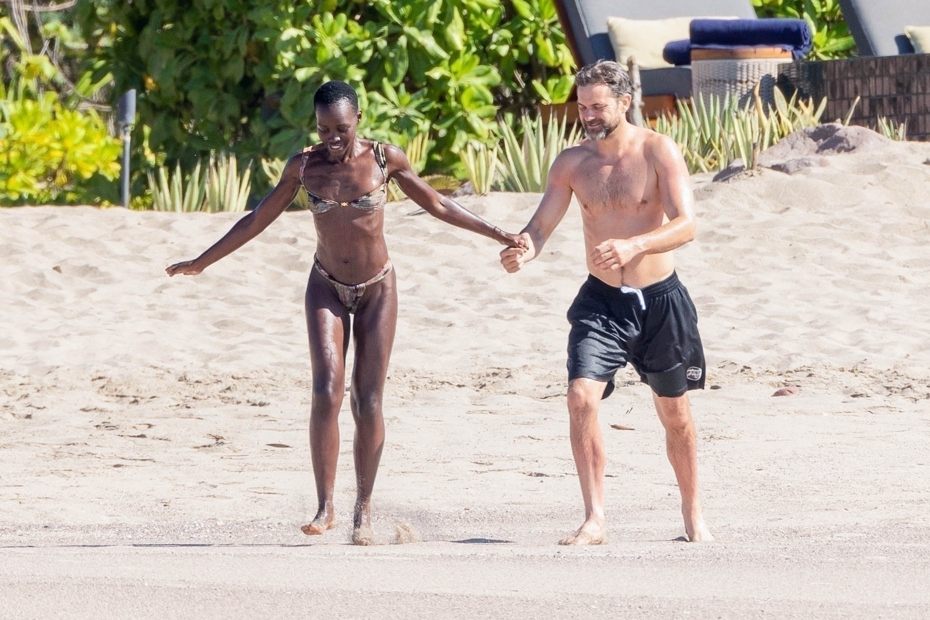 Lupita Nyong'o and Joshua Jackson on the beach in Mexico.