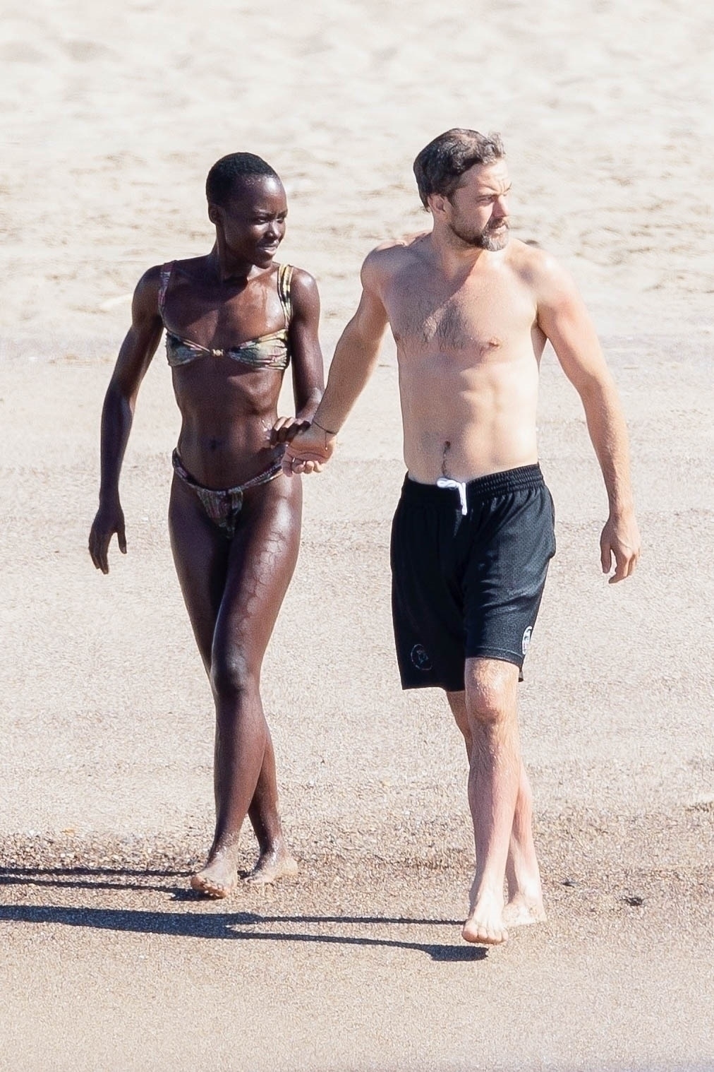 Lupita Nyong'o and Joshua Jackson on the beach in Mexico.