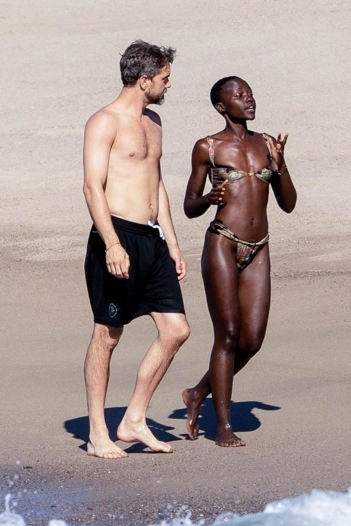 Lupita Nyong'o and Joshua Jackson on the beach in Mexico.