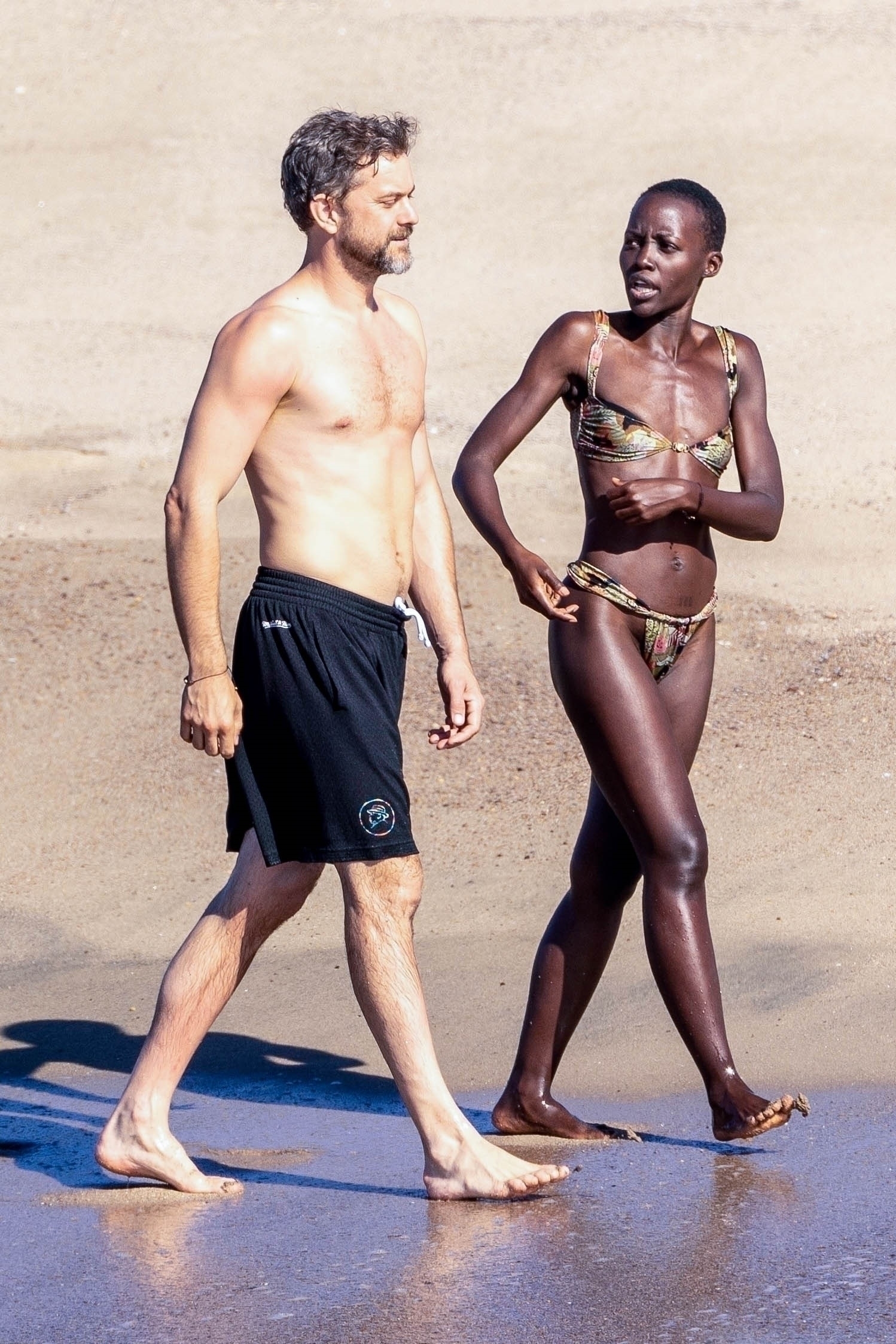 Lupita Nyong'o and Joshua Jackson on the beach in Mexico.