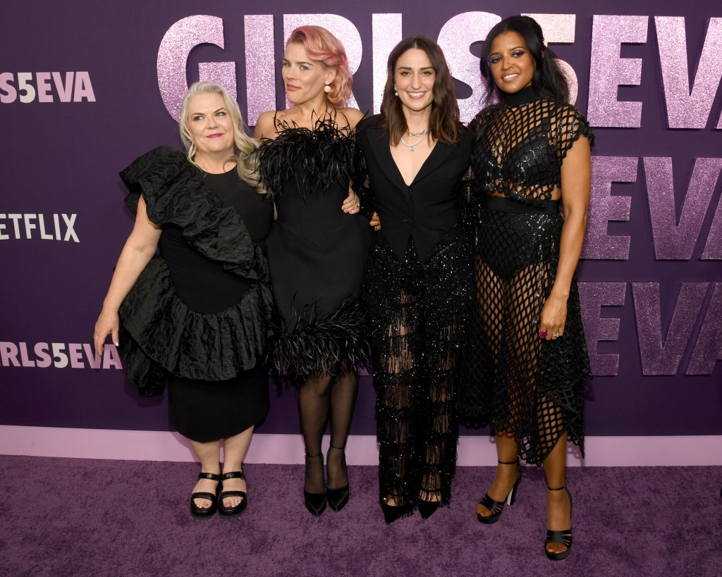 Cast of "Glam5Eva" posing on red carpet.