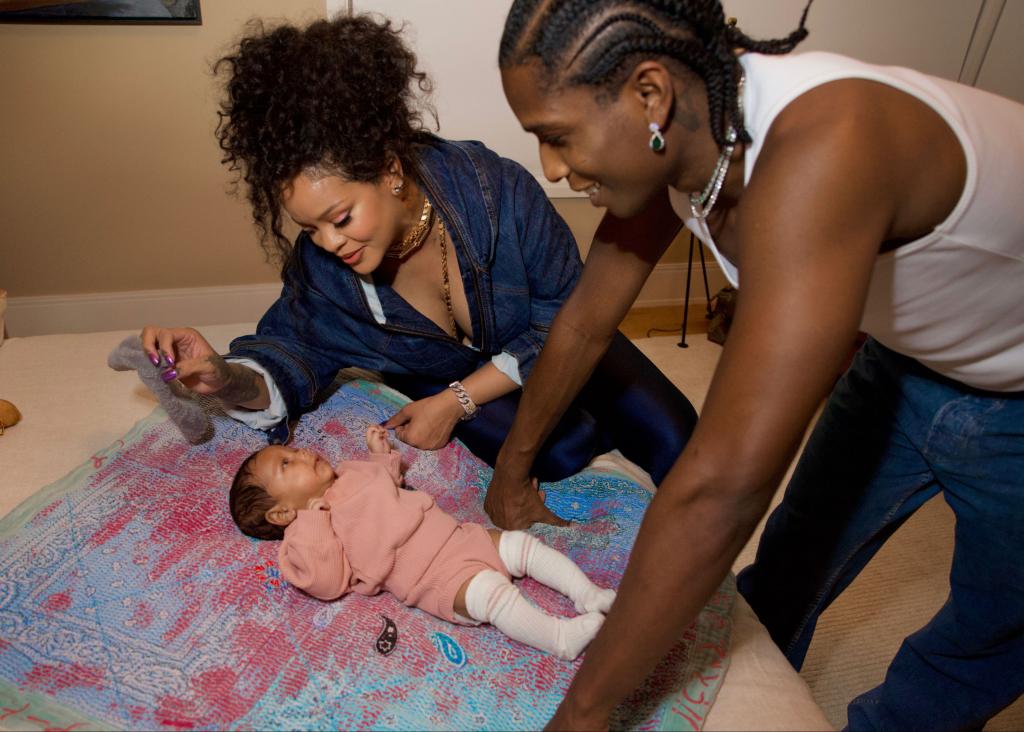 Rihanna and A$AP Rocky pose with baby Riot. 