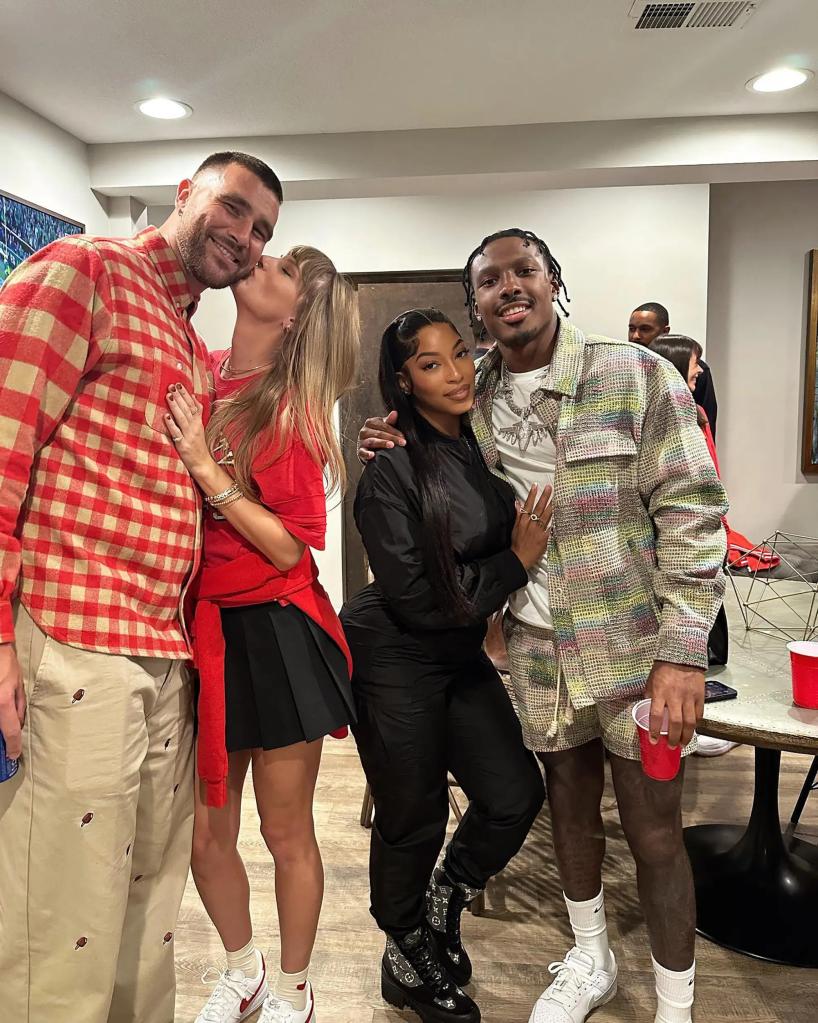 taylor swift kissing travis kelce on the cheek next to a different couple