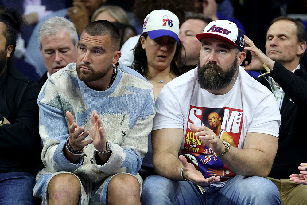 Travis Kelce of the Kansas City Chiefs and Jason Kelce of the Philadelphia Eagles watch game six of the Eastern Conference Semifinals in the 2023 NBA Playoffs between the Boston Celtics and the Philadelphia 76ers at Wells Fargo Center on May 11, 2023