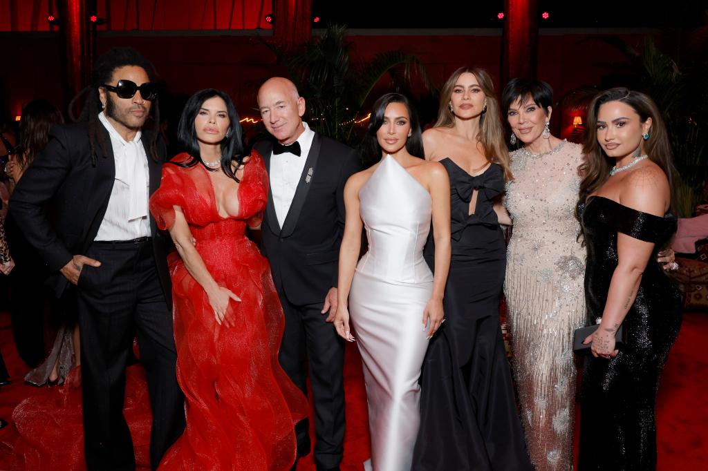 Lenny Kravitz, Lauren Sanchez, Jeff Bezos, Kim Kardashian, Sofia Vergara, Kris Jenner, and Demi Lova pose at the Vanity Fair party.