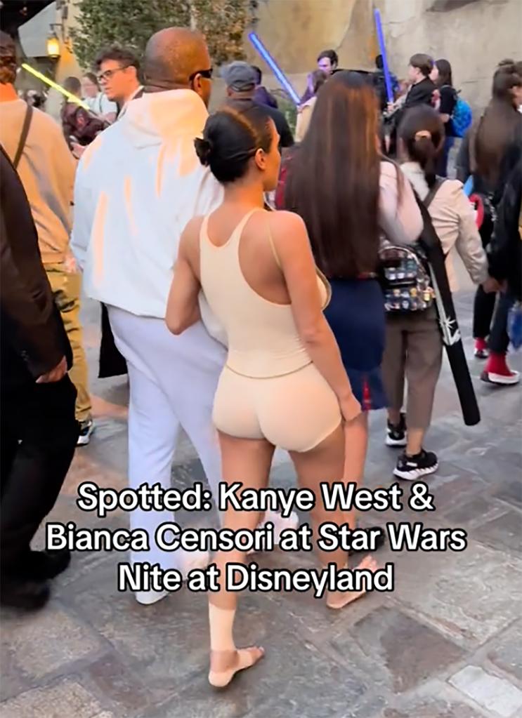 Bianca Censori and Kanye West in Disneyland.