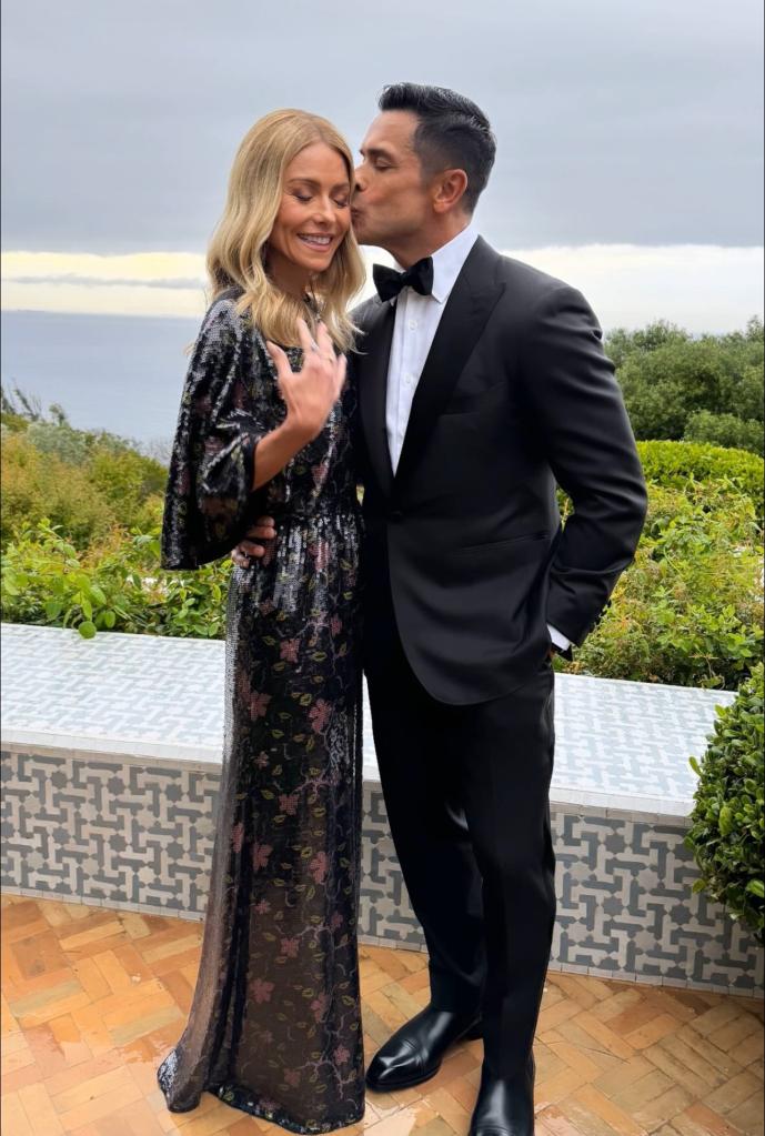 Mark Consuelos kissing Kelly Ripa