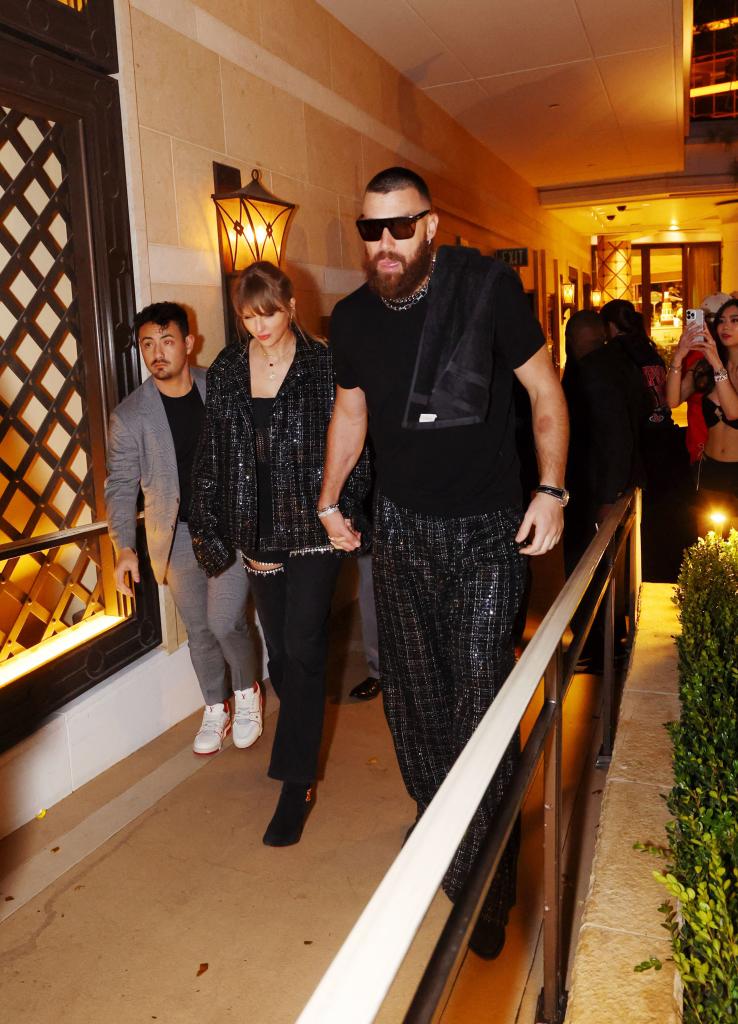 Taylor Swift and Travis Kelce holding hands in Las Vegas. 