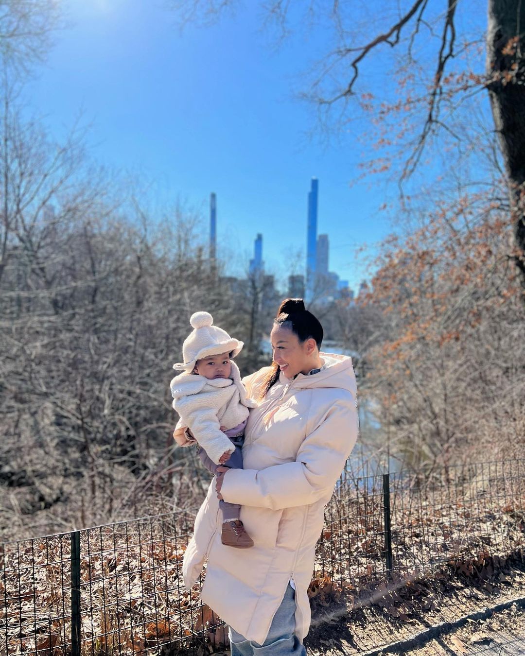 Jeannie Mai holding her daughter, Monaco, at the park.