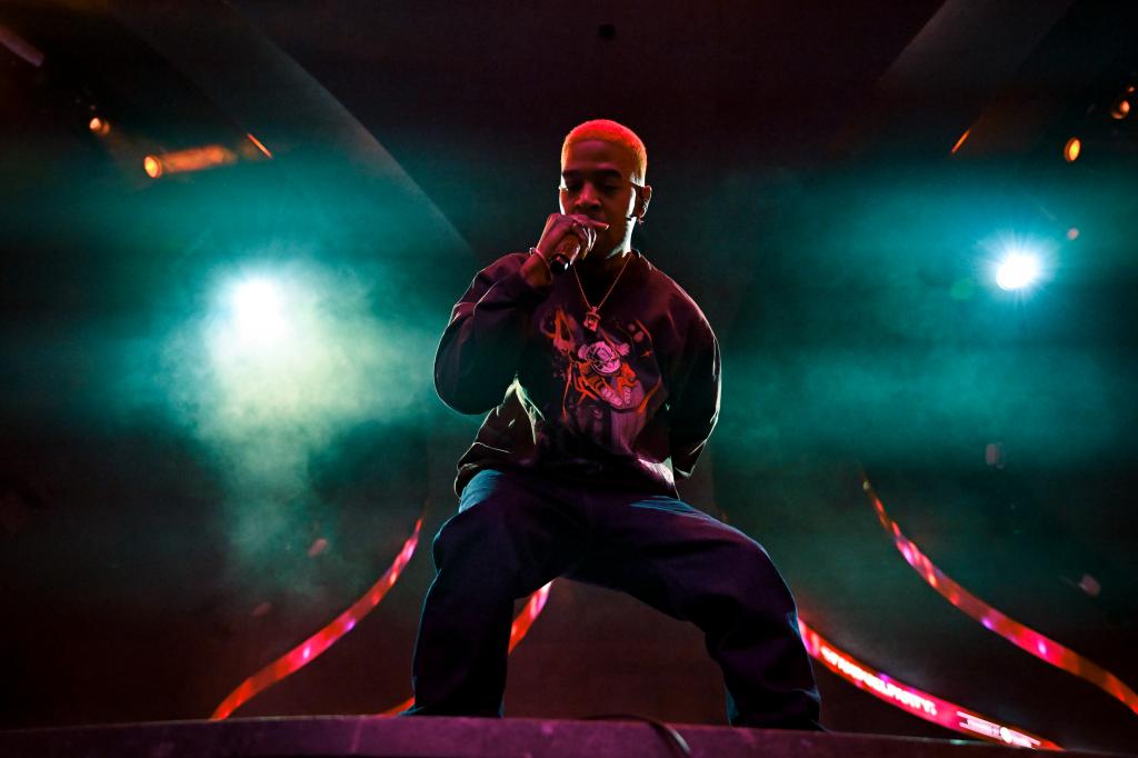 Kid Cudi performing on stage. 