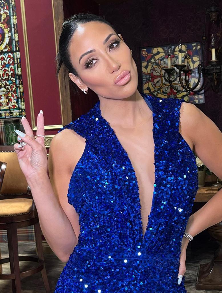 Melissa Gorga throwing up a peace sign.