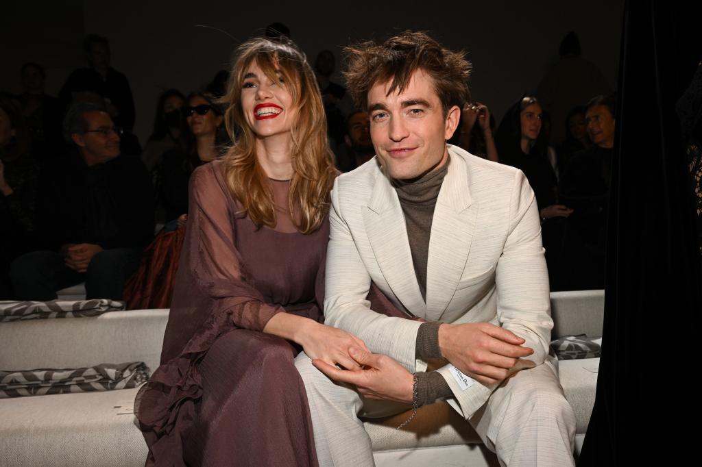 Suki Waterhouse and Robert Pattinson  at a fashion show in 2022.