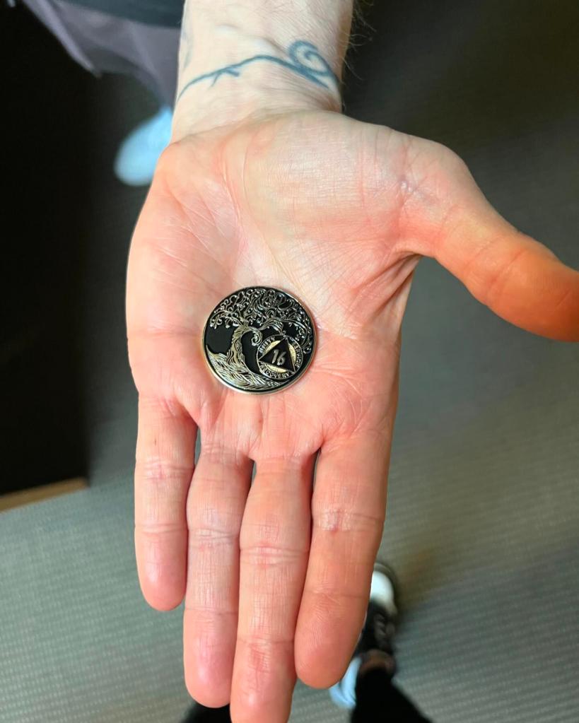 Eminem holding his sobriety chip.