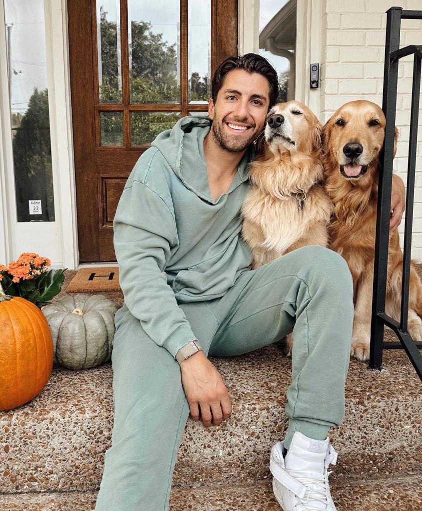 Jason Tartick with two golden retrievers