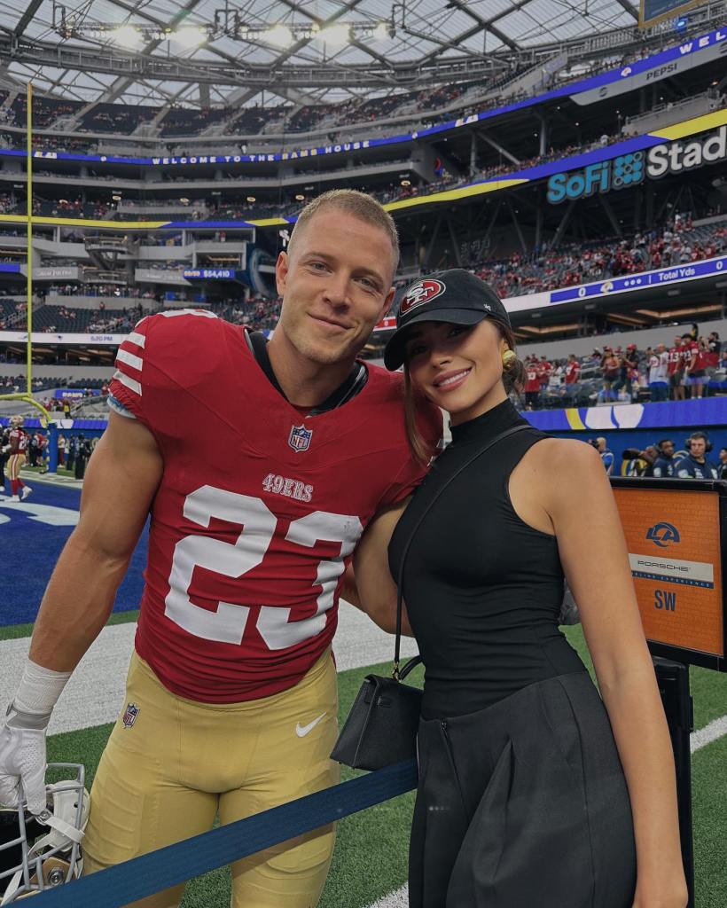 Christian McCaffrey and Olivia Culpo at a football game. 