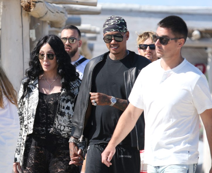 Cher and Alexander "AE" Edwards holding hands.