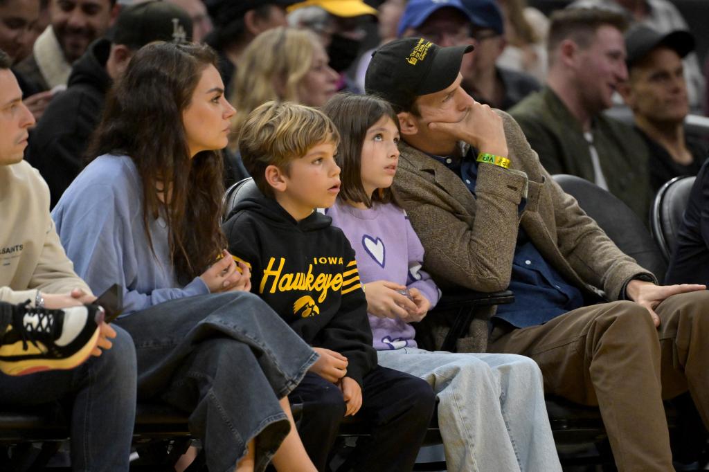 Mila Kunis and Ashton Kutcher with their kids, Wyatt and Dimitri, watching basketball