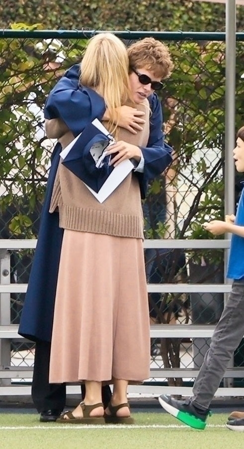 Moses Martin hugging Gwyneth Paltrow at his graduation. 