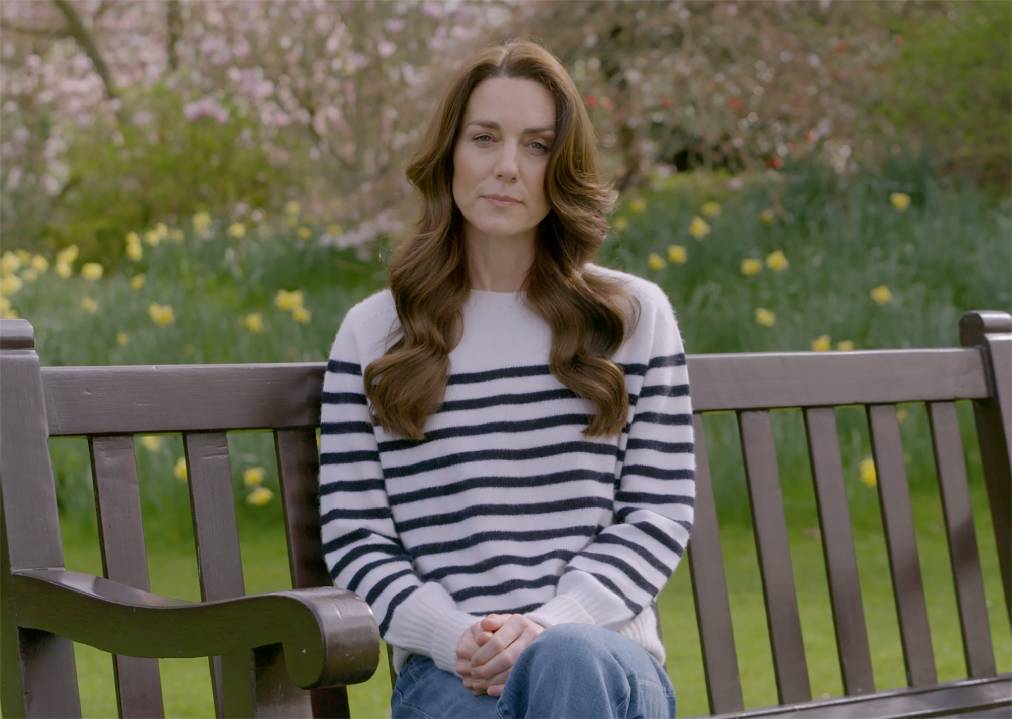 Kate Middleton sitting on a bench.