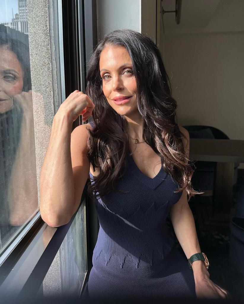 Bethenny Frankel leaning on a window. 