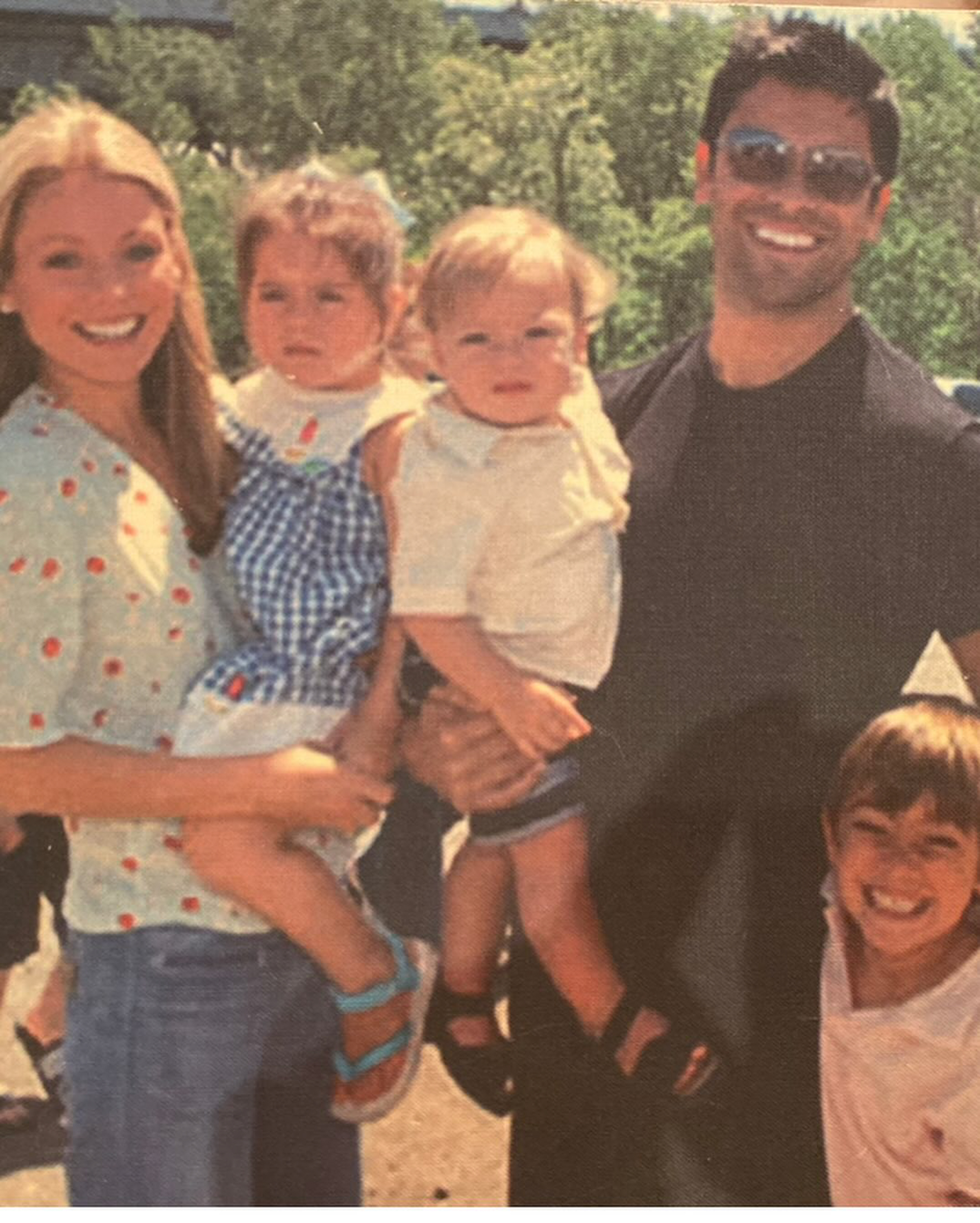 A throwback photo of Kelly Ripa and Mark Consuelos posing with their kids