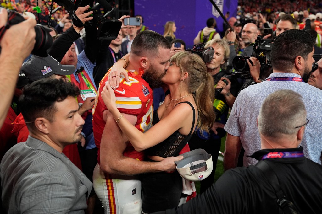 Taylor Swift and Travis Kelce kissing at the 2024 Super Bowl. 