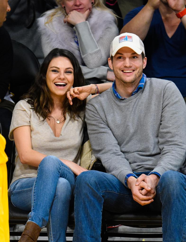 Mila Kunis and Ashton Kutcher watching basketball