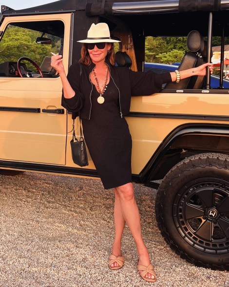 Luann de Lesseps smoking a cig outside of an SUV