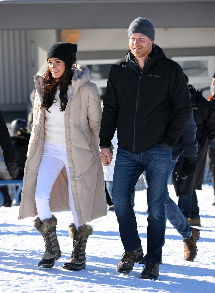 Prince Harry and Meghan Markle holding hands. 