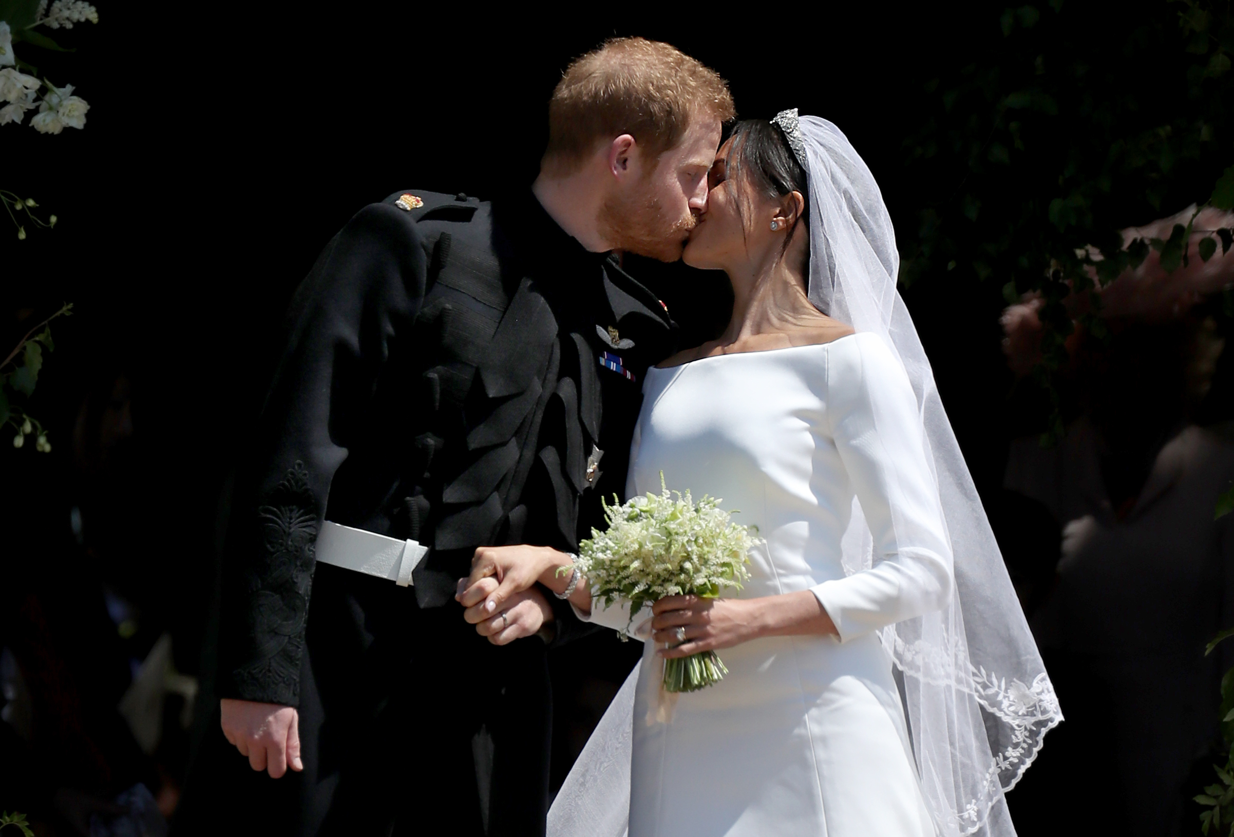 Prince Harry and Meghan Markle kiss outside St George's Chapel