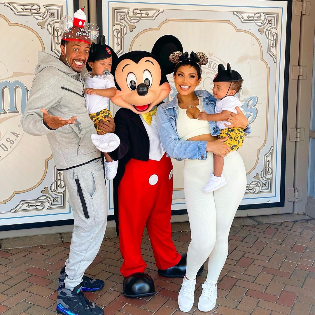 Nick Cannon and Abby De La Rosa with their kids and MIckey Mouse.