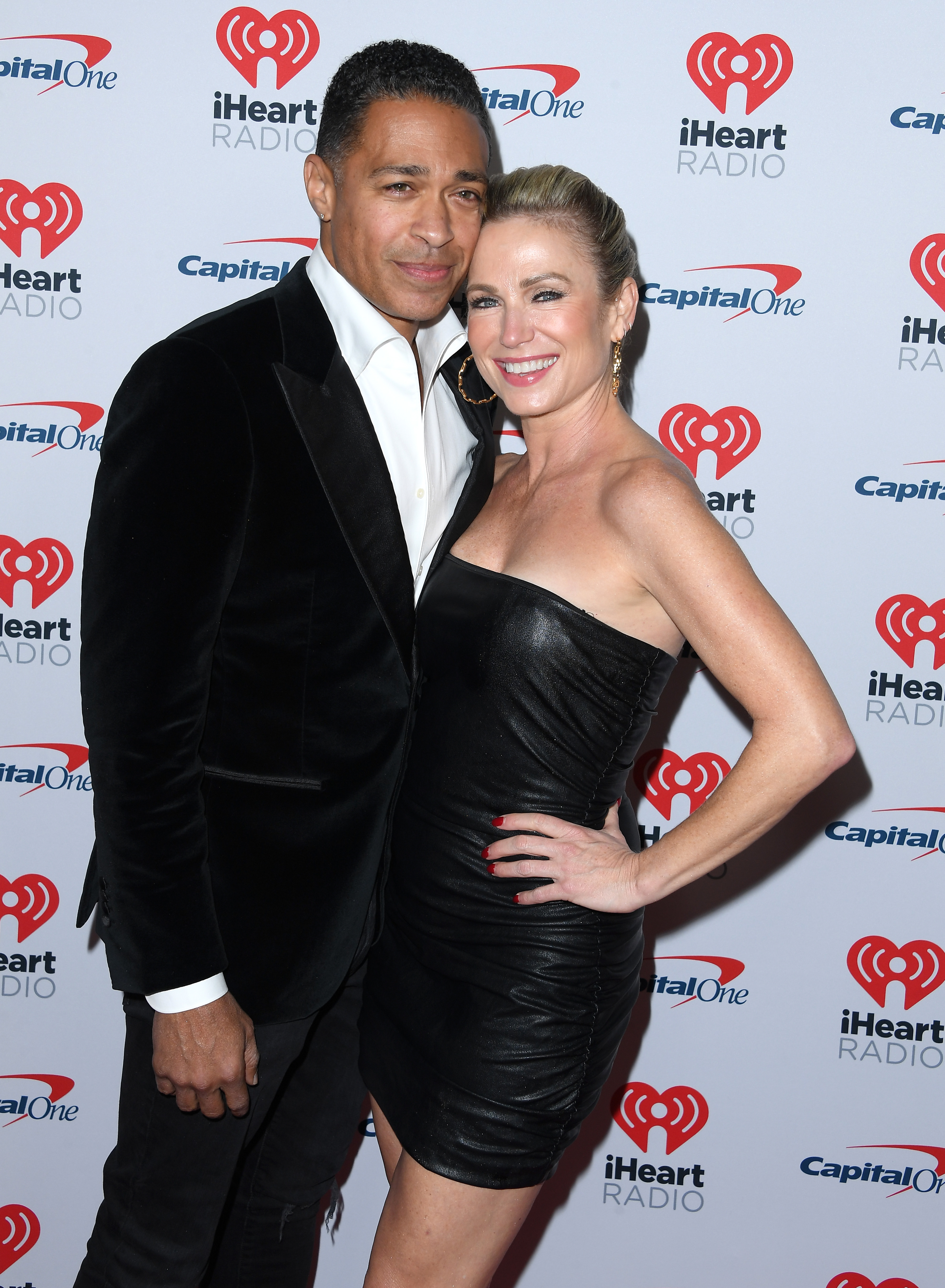 T.J. Holmes and Amy Robach on a red carpet.